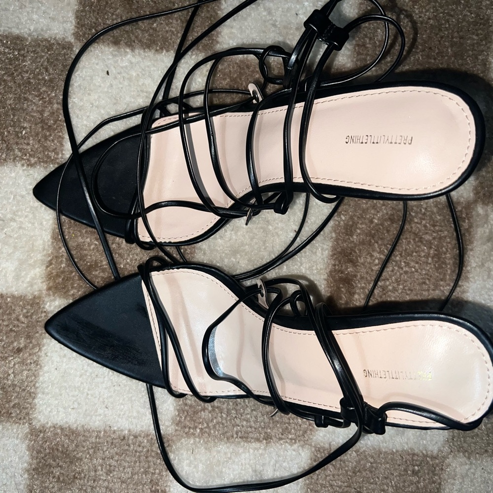 Pretty little thing strap up leg heels .